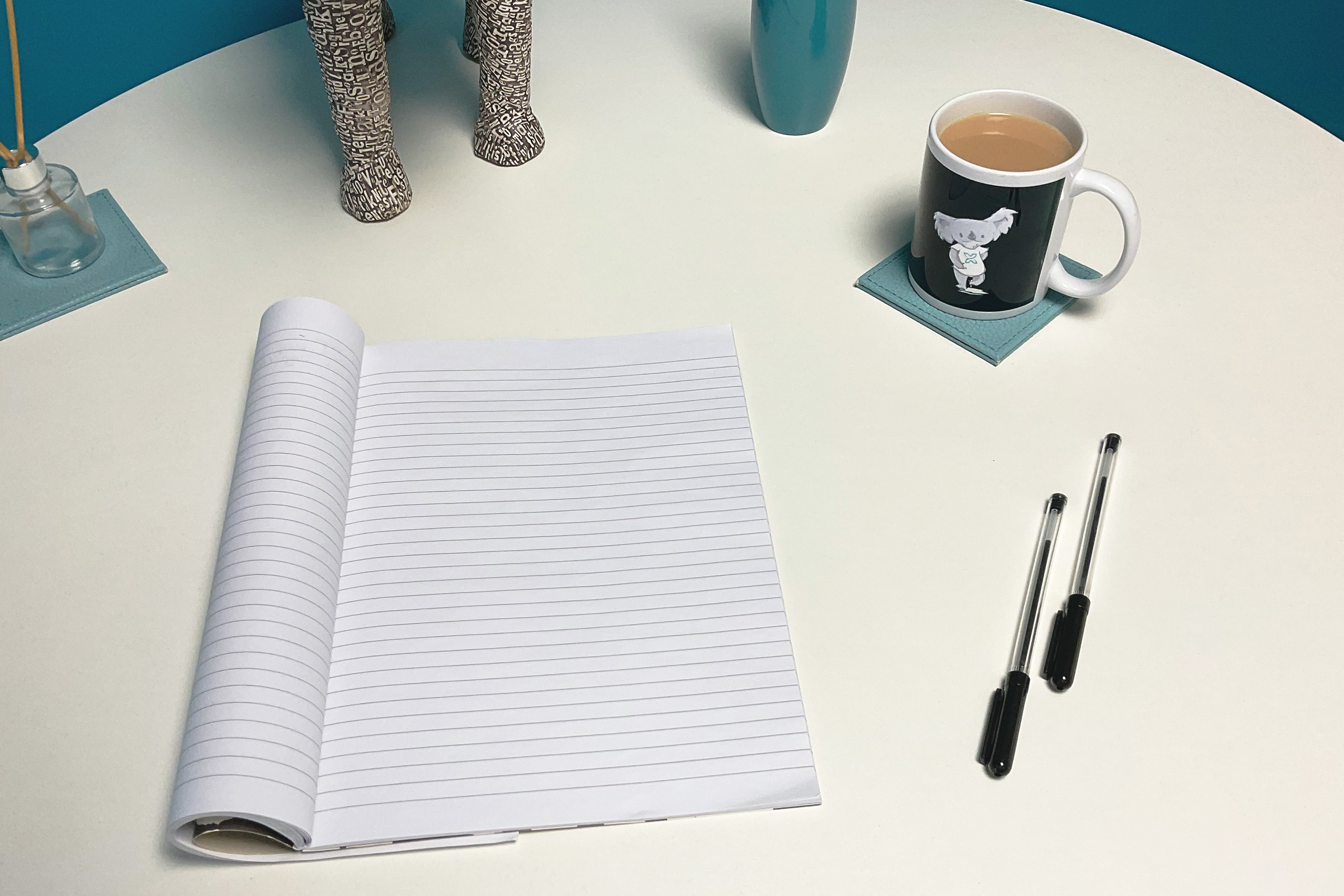Social media content calendar August | Picture-of-notepad-and-pens-with-koala-digital-mug